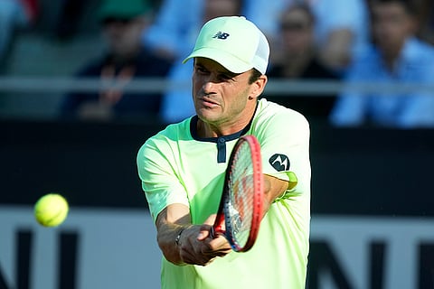 Tommy Paul returns the ball to Daniil Medvedev